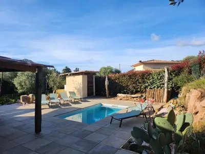 a backyard with a swimming pool and a house at A l'Ombra Di l'Alivu in Figari