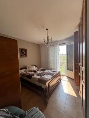 a bedroom with a bed and a window at Villa Santa Rita in Lucciana