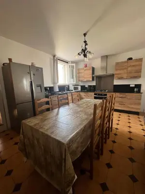 a large kitchen with a large wooden table and chairs at Villa Santa Rita in Lucciana