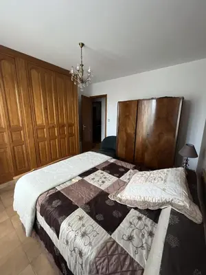 a bedroom with a large bed with a wooden headboard at Villa Santa Rita in Lucciana