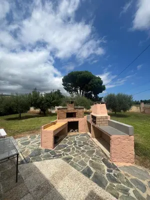 a brick oven on top of a stone patio at Villa Santa Rita in Lucciana
