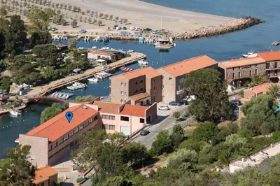 an aerial view of a town with a marina at Résidence Hotelière Capu Seninu in Porto Ota