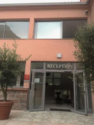 an entrance to a building with a revolving door at Résidence Hotelière Capu Seninu in Porto Ota