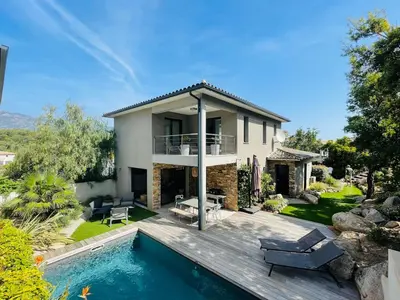 a villa with a swimming pool and a house at Villa La Vesta Porto Vecchio in Porto-Vecchio