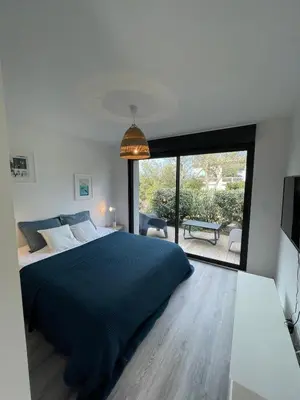a bedroom with a large bed and a large window at Villa La Vesta Porto Vecchio in Porto-Vecchio