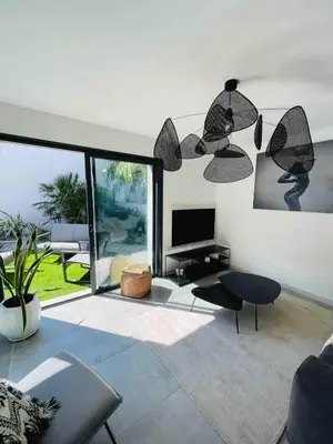 a living room with a couch and a television at Villa La Vesta Porto Vecchio in Porto-Vecchio