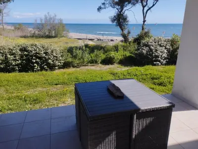 a black table with a view of the beach at T2 Waterfront Linguizzetta in Linguizzetta