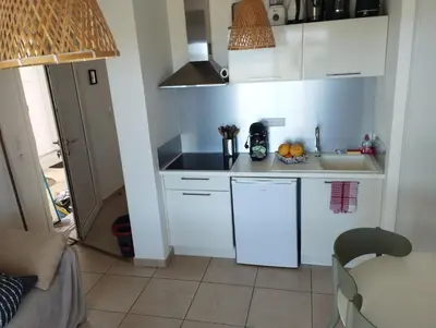 a small kitchen with white cabinets and a sink at T2 Waterfront Linguizzetta in Linguizzetta
