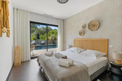 a bedroom with a large bed with towels on it at Villa 