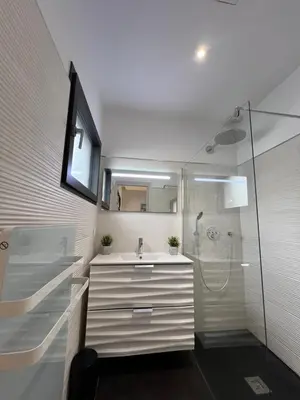 a bathroom with a sink and a shower at Villa 