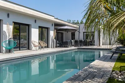 a swimming pool in front of a house at Villa 