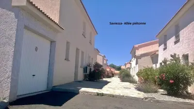 a alleyway between two buildings in a town at Villa bord de mer,3 chambres, piscine chauffée, climatisée in Cervione