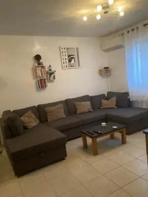 a living room with a couch and a coffee table at Villa bord de mer,3 chambres, piscine chauffée, climatisée in Cervione