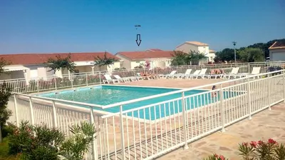 a swimming pool with a white fence around it at Villa bord de mer,3 chambres, piscine chauffée, climatisée in Cervione