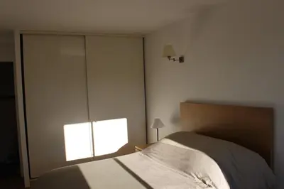 a bedroom with a bed and a large window at Quenza-Alta Rocca in Quenza