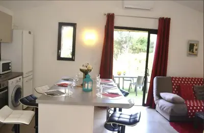 a kitchen and living room with a table and a couch at Les Bergeries de Petralonga in Sotta