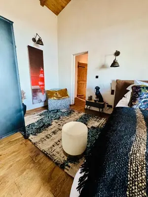 a bedroom with a bed and a couch and a chair at Terradigaya in Pietrosella