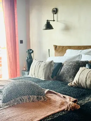 a bedroom with a bed with pillows on it at Terradigaya in Pietrosella