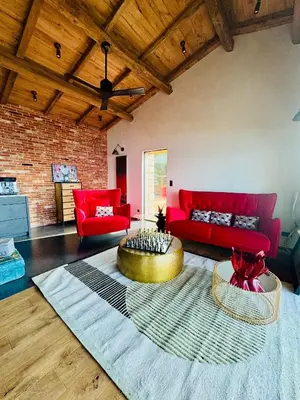 a living room with red couches and a table at Terradigaya in Pietrosella