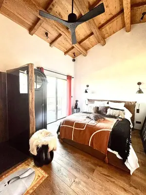 a bedroom with a bed and a wooden ceiling at Terradigaya in Pietrosella