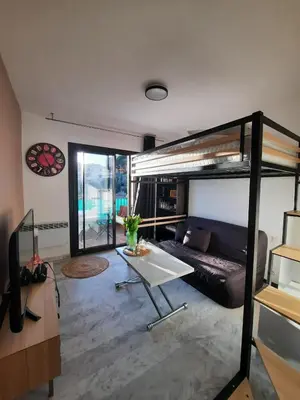 a living room with a bunk bed and a couch at Studio vue mer Sanguinaires 3 minutes des plages in Ajaccio