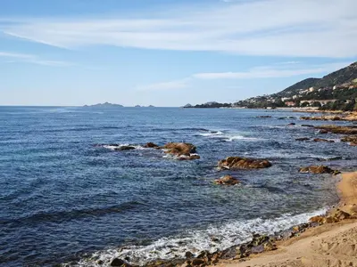 a view of the ocean with rocks in the water at Studio vue mer Sanguinaires 3 minutes des plages in Ajaccio