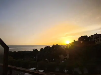 a sunset from the balcony of a building at Studio vue mer Sanguinaires 3 minutes des plages in Ajaccio