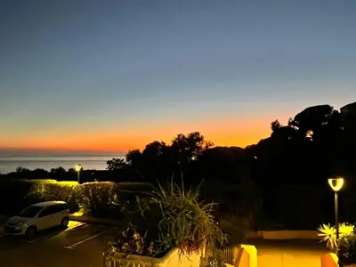 a car parked in a parking lot at sunset at Studio vue mer Sanguinaires 3 minutes des plages in Ajaccio