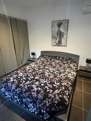 a bedroom with a bed with a bunch of flowers at Maison individuelle type F2 in Alata