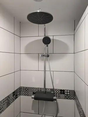 a shower in a bathroom with a shower head at L'Attellu di Babbu in Lecci