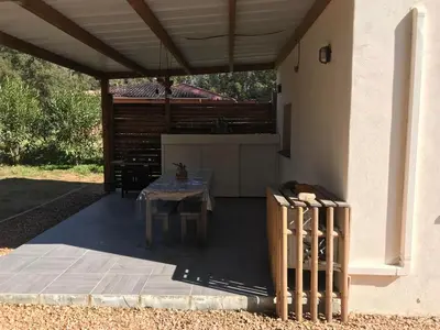 a patio with a table under a roof at L'Attellu di Babbu in Lecci