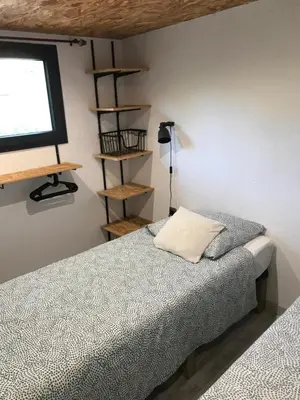 a bedroom with a bed and a television on a wall at L'Attellu di Babbu in Lecci