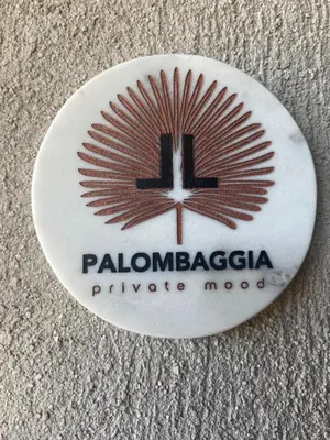 a white button with a palomarazacco logo at Palombaggia Camara - Lecci Lodge in Lecci