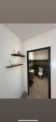 a bathroom with a toilet and a sink and a mirror at Villa Mawie in Sotta