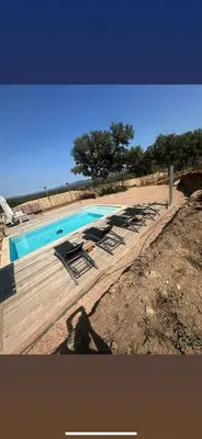 a swimming pool with lounge chairs next to the beach at Villa Mawie in Sotta
