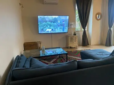 a living room with a couch and a flat screen tv at Maison de charme in Sotta
