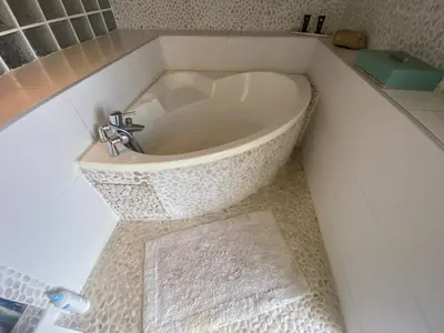 a bathroom with a sink in the middle of a tub at Maison de charme in Sotta