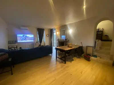 a living room with a table and a couch at Maison de charme in Sotta