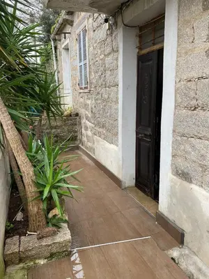 an entrance to a building with a black door at Maison de charme in Sotta