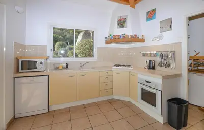 a kitchen with a sink and a microwave at Cozy Home In Porto-Vecchio in Porto-Vecchio