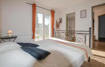 a white bed in a bedroom with a window at Cozy Home In Porto-Vecchio in Porto-Vecchio