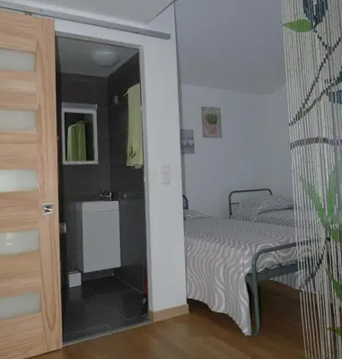 a small bedroom with a bed and a bathroom at In Tavignanu in Sortipiani