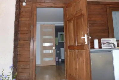 an open wooden door in a kitchen with a counter at In Tavignanu in Sortipiani
