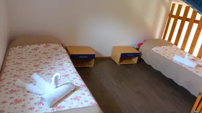 a room with two beds and two night stands at In Tavignanu in Sortipiani