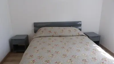 a bedroom with a bed with two night stands at In Tavignanu in Sortipiani
