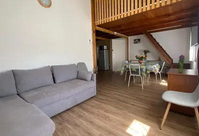 a living room with a gray couch and a table at In Tavignanu in Sortipiani
