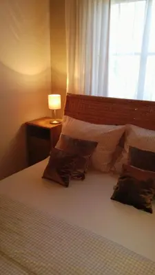 a bedroom with a bed with pillows and a window at Kallista 1 in San-Giuliano
