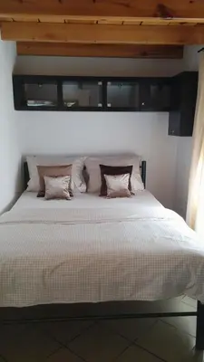 a bedroom with a large white bed with pillows at Kallista 1 in San-Giuliano