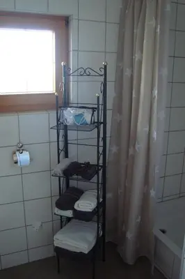a towel rack in a bathroom next to a shower at Kallista 1 in San-Giuliano