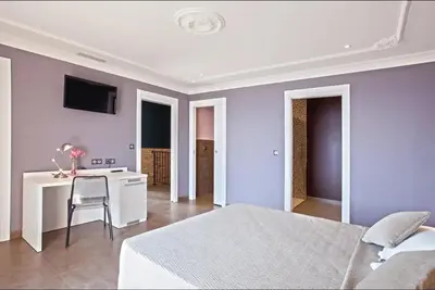 a bedroom with a bed and a table and a desk at Appartement avec vue sur la mer à Olmeto in Olmeto